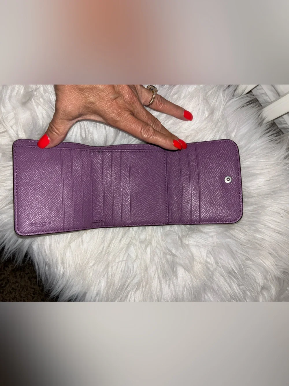Coach Compact Trifold Pebbled Leather Wallet button closure in Plum/Purple.